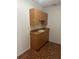 Functional laundry room featuring ample cabinetry, countertop space, and a convenient utility sink at 5480 Summerland Hills Dr, Lakeland, FL 33812