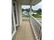 Cozy porch with tiled flooring and white railing, offering a pleasant outdoor space to relax and enjoy the neighborhood views at 5480 Summerland Hills Dr, Lakeland, FL 33812