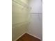 Spacious walk-in closet featuring wooden floors, and white wire shelving for optimal storage and organization at 5480 Summerland Hills Dr, Lakeland, FL 33812