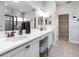 Bathroom featuring double sinks, vanity with stool, and glass enclosed shower at 561 Silver Course Run, Ocala, FL 34472