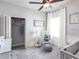 Comfortable Bedroom with a crib, rocking chair, and soft carpet, ideal for relaxation and play at 561 Silver Course Run, Ocala, FL 34472