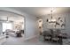 Beautiful dining room with chandelier lighting fixture and stylish decor at 561 Silver Course Run, Ocala, FL 34472
