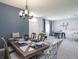 Inviting dining room with a chandelier, table seating, and views of the game room at 561 Silver Course Run, Ocala, FL 34472