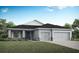 Charming single-story home with a well-manicured lawn and a two-car garage on a sunny day at 561 Silver Course Run, Ocala, FL 34472