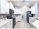 Bright kitchen featuring modern appliances, white cabinets, and mosaic backsplash at 561 Silver Course Run, Ocala, FL 34472