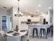 Modern kitchen with a breakfast bar, stainless steel appliances, and ample counter space at 561 Silver Course Run, Ocala, FL 34472