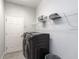 Neat laundry room featuring modern appliances and shelving for storage at 561 Silver Course Run, Ocala, FL 34472