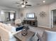 Comfortable living room featuring ceiling fan and neutral color palette at 561 Silver Course Run, Ocala, FL 34472