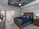 Spacious bedroom with tray ceiling, blue accent, and modern furnishings at 561 Silver Course Run, Ocala, FL 34472