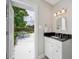 Updated bathroom opens to backyard with hammock, with granite vanity and outdoor view at 5619 Stratford Ln, Lakeland, FL 33813