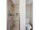 Modern bathroom featuring a tiled walk-in shower and a sleek toilet at 5619 Stratford Ln, Lakeland, FL 33813