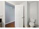 Clean bathroom with neutral wall paint, new toilet, and hardwood flooring at 5619 Stratford Ln, Lakeland, FL 33813