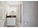 Cozy bathroom featuring updated vanity, mirror, and a tiled shower behind a doorway at 5619 Stratford Ln, Lakeland, FL 33813