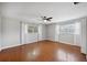 A bright bedroom featuring hardwood floors, neutral walls, ceiling fan and natural light at 5619 Stratford Ln, Lakeland, FL 33813