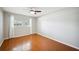 Bright, neutral bedroom with hardwood floors, a ceiling fan, and sunlit windows at 5619 Stratford Ln, Lakeland, FL 33813