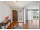 Foyer with hardwood floors, decorative table, and view to the living area at 5619 Stratford Ln, Lakeland, FL 33813
