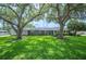Charming single-story home with lush green lawn and mature trees providing shade at 5619 Stratford Ln, Lakeland, FL 33813