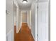 Hallway with hardwood floors leads to various rooms throughout the residence at 5619 Stratford Ln, Lakeland, FL 33813
