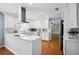 Bright kitchen with stainless appliances, granite countertops, and white cabinetry at 5619 Stratford Ln, Lakeland, FL 33813