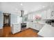 Updated kitchen with stainless steel appliances, white cabinets, and island cooktop at 5619 Stratford Ln, Lakeland, FL 33813