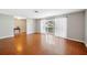 Bright living room boasts hardwood floors, fresh paint and large windows for natural light at 5619 Stratford Ln, Lakeland, FL 33813