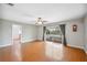 Spacious living room featuring wood floors, ceiling fan, and screened-in porch access at 5619 Stratford Ln, Lakeland, FL 33813