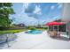 Relaxing backyard pool area with a hammock, patio furniture, and a lush lawn at 5619 Stratford Ln, Lakeland, FL 33813