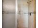 A close-up of a shower featuring tiled walls, a shower niche, and updated fixtures at 5619 Stratford Ln, Lakeland, FL 33813