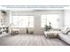 Bright, spacious living room featuring light wood-look vinyl flooring, large windows, white sofa, and modern decor at 563 Silver Course Radl, Ocala, FL 34472