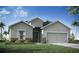 Charming single-story home with a gray facade, attached two-car garage, and well-manicured lawn at 569 Silver Course Radl, Ocala, FL 34472