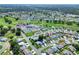 High aerial view of a community's homes, pool and golf course at 5857 Macaw Pl, Lakeland, FL 33809