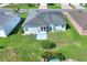Aerial view of home, highlighting the lush lawn, modern patio, and the neatly maintained surroundings at 5857 Macaw Pl, Lakeland, FL 33809