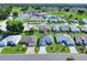 An aerial shot featuring a residential neighborhood home next to a landscaped parkway at 5857 Macaw Pl, Lakeland, FL 33809