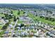 Aerial view of a community near a golf course with clubhouse and swimming pool at 5857 Macaw Pl, Lakeland, FL 33809