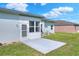 Back patio with screen door and concrete patio, offering a relaxing outdoor space at 5857 Macaw Pl, Lakeland, FL 33809