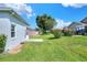Well-maintained backyard featuring lush green grass and vibrant flowering shrubs at 5857 Macaw Pl, Lakeland, FL 33809