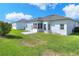 A well-maintained backyard featuring a concrete patio and lush green grass at 5857 Macaw Pl, Lakeland, FL 33809