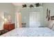 Bedroom featuring a large closet, light green walls, and a floral patterned quilt at 5857 Macaw Pl, Lakeland, FL 33809