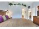 Comfortable bedroom featuring a queen bed, soft lighting, and stylish decor overlooking the ensuite bathroom at 5857 Macaw Pl, Lakeland, FL 33809