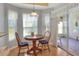 Sunlit breakfast nook with a round wooden table and chairs, next to sliding doors at 5857 Macaw Pl, Lakeland, FL 33809
