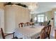 Dining area featuring a chandelier and large table, flowing into a spacious living room with natural light at 5857 Macaw Pl, Lakeland, FL 33809