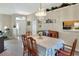 Open dining area with chandelier, adjacent to a cozy living room and leading to the main entrance at 5857 Macaw Pl, Lakeland, FL 33809