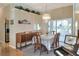 Formal dining room with a crystal chandelier and seating for six, creating an inviting atmosphere at 5857 Macaw Pl, Lakeland, FL 33809