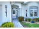 Inviting front entrance with stone walkway, lush landscaping, and light blue walls at 5857 Macaw Pl, Lakeland, FL 33809