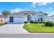 Charming one-story home with a well-manicured lawn and a paved driveway leading to a two-car garage at 5857 Macaw Pl, Lakeland, FL 33809