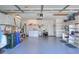 Spacious garage featuring a utility sink, washer and dryer, and storage shelves at 5857 Macaw Pl, Lakeland, FL 33809