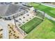 Aerial shot showcases the driving range with hitting stations, putting green, golf carts, and clubhouse at 5857 Macaw Pl, Lakeland, FL 33809