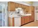 Well-lit kitchen featuring ample cabinetry, a double sink, and sliding glass doors leading to outdoor area at 5857 Macaw Pl, Lakeland, FL 33809