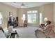 Comfortable living room featuring plush carpet flooring, light walls, ample natural light, and comfortable seating at 5857 Macaw Pl, Lakeland, FL 33809
