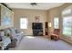 Spacious living room with carpet flooring, light walls, ample natural light, and comfortable seating arrangements at 5857 Macaw Pl, Lakeland, FL 33809